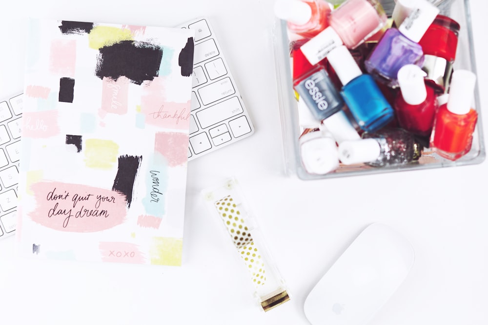 assorted nail color bottles beside keyboard