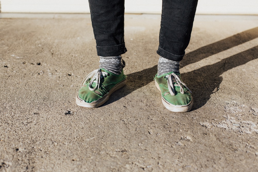 person wearing green low-top sneakers while standing