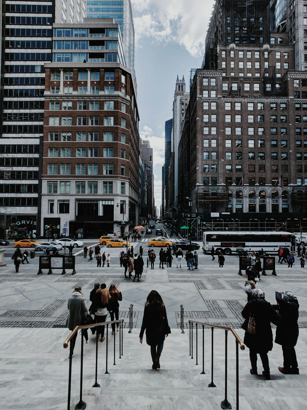 people waking on concrete staircase