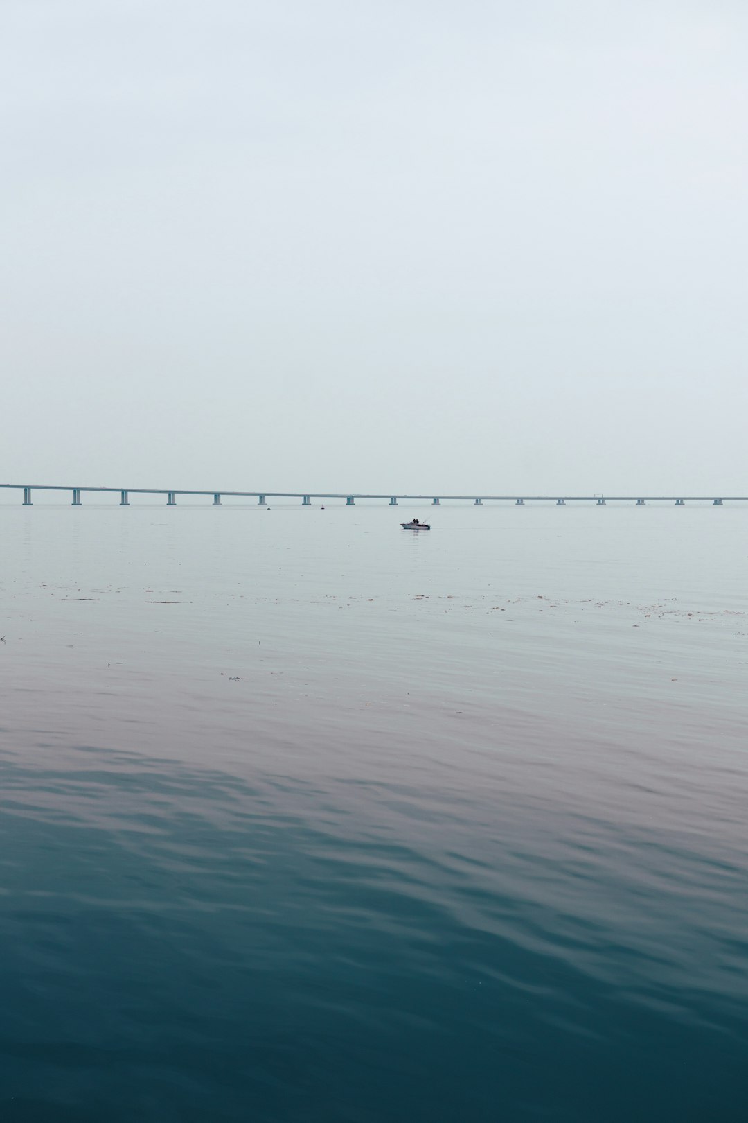 boat on body of water near bridge