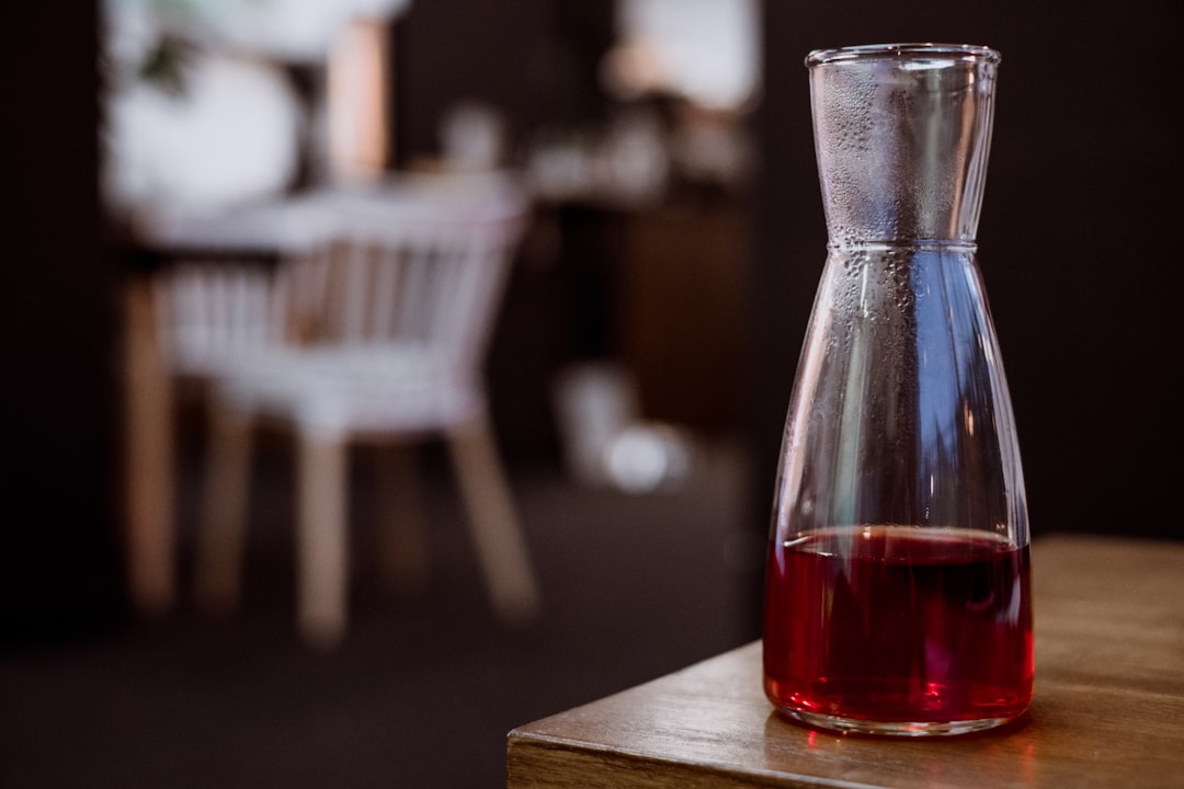 clear glass bottled filled with red liquid