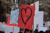 person holding up love sign