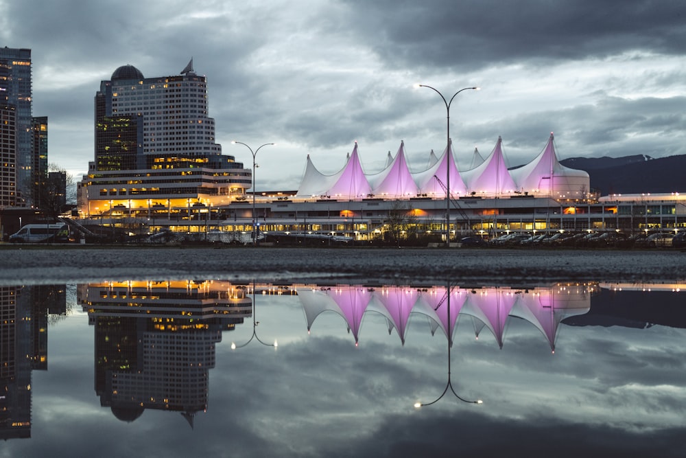 photo of concrete buildings near body of water