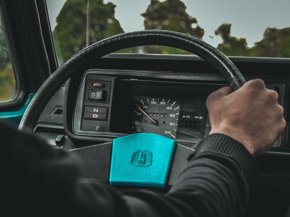 person holding steering wheel