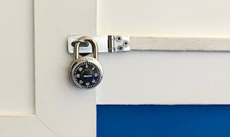 closeup photo of round gray combination padlock