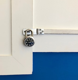 closeup photo of round gray combination padlock