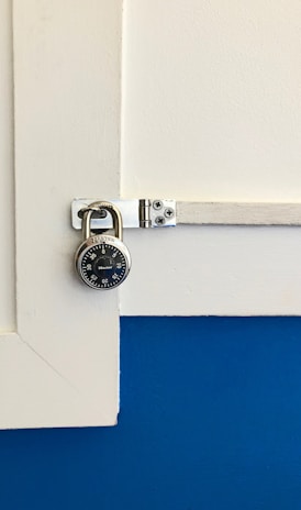 closeup photo of round gray combination padlock