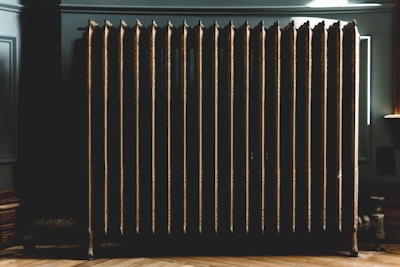 Close-up of a modern freestanding radiator cover with intricate milling details.