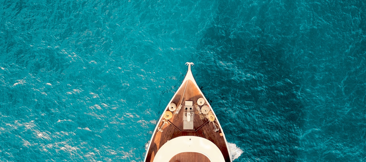 birds eye photography of boat on body of water