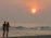 Smiling couple enjoying a sunset beach walk in the Maldives.