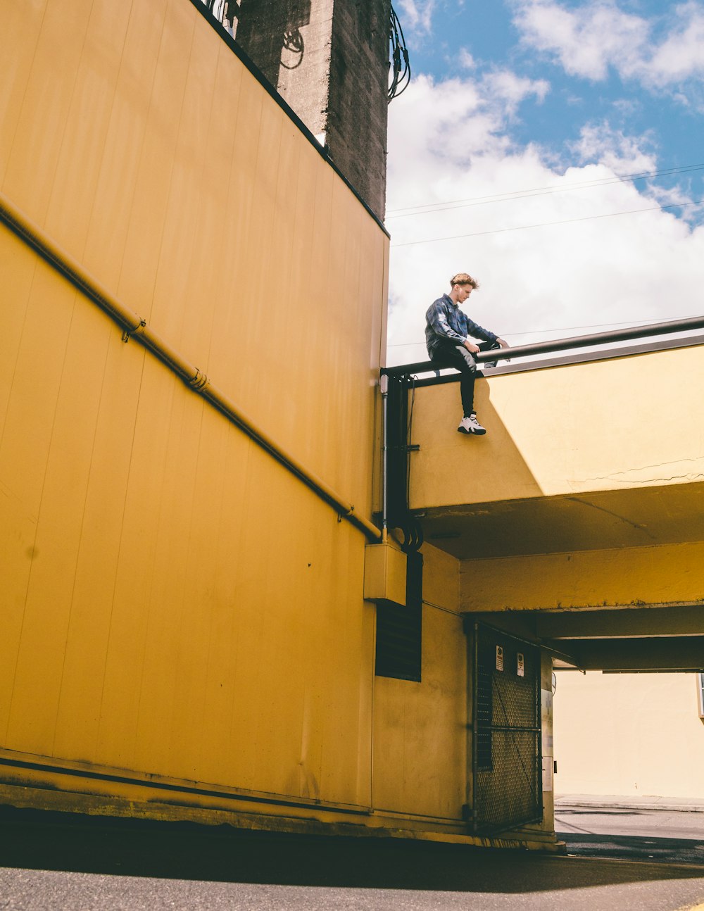 man sitting on bridge