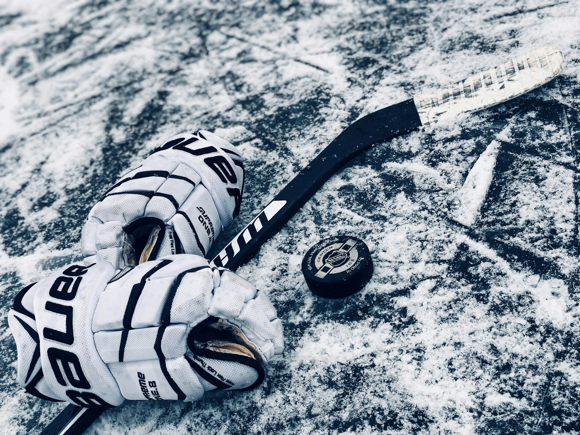black ice hockey beside gloves