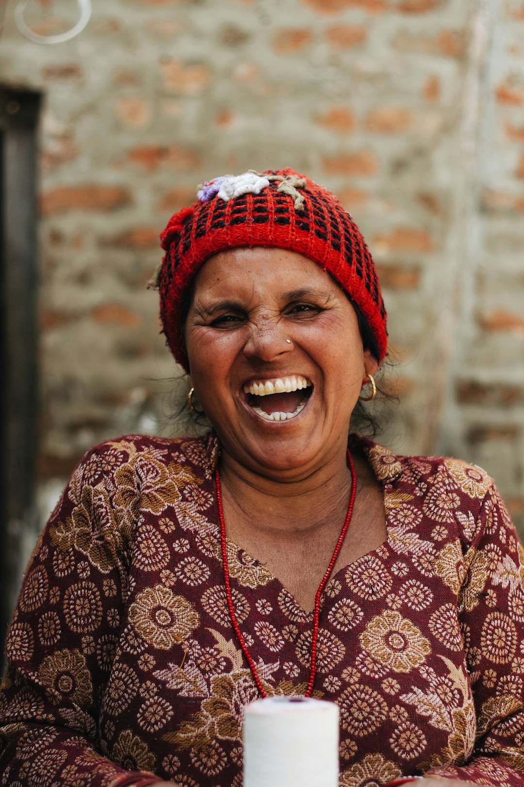 woman in red snitted cap laughing her ass off
