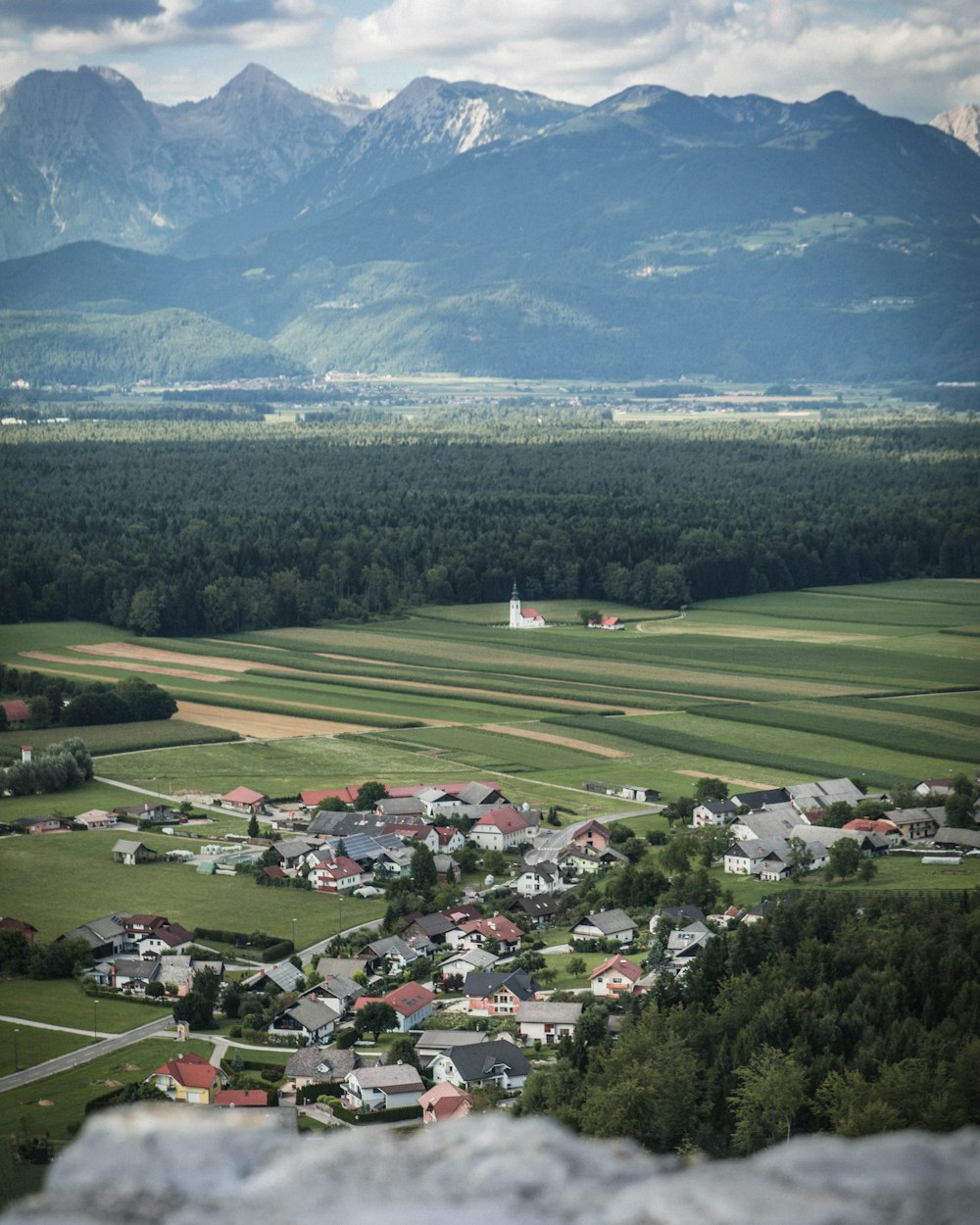 high-angle photo of establishment in front of mountain