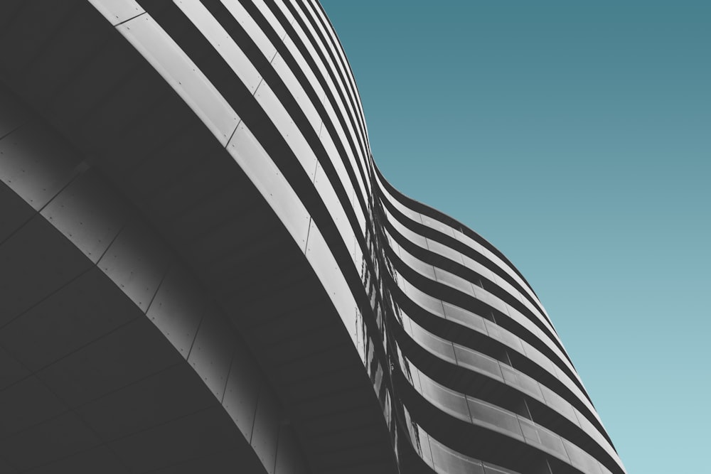 Fotografie aus der Wurmperspektive eines grauen Gebäudes unter blauem Himmel während des Tages