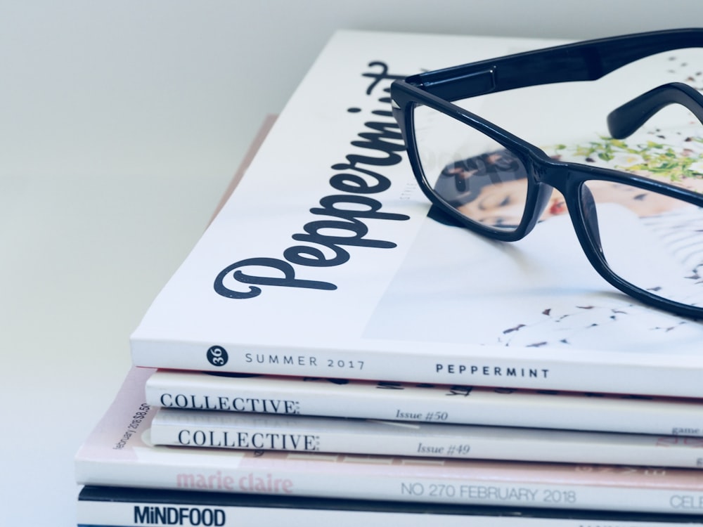 black framed eyeglasses on book