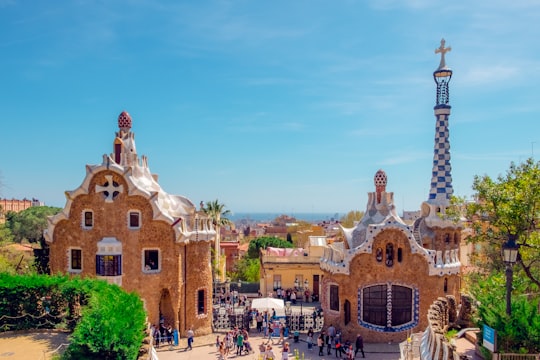 group of people walking near brown church in Park Güell Spain