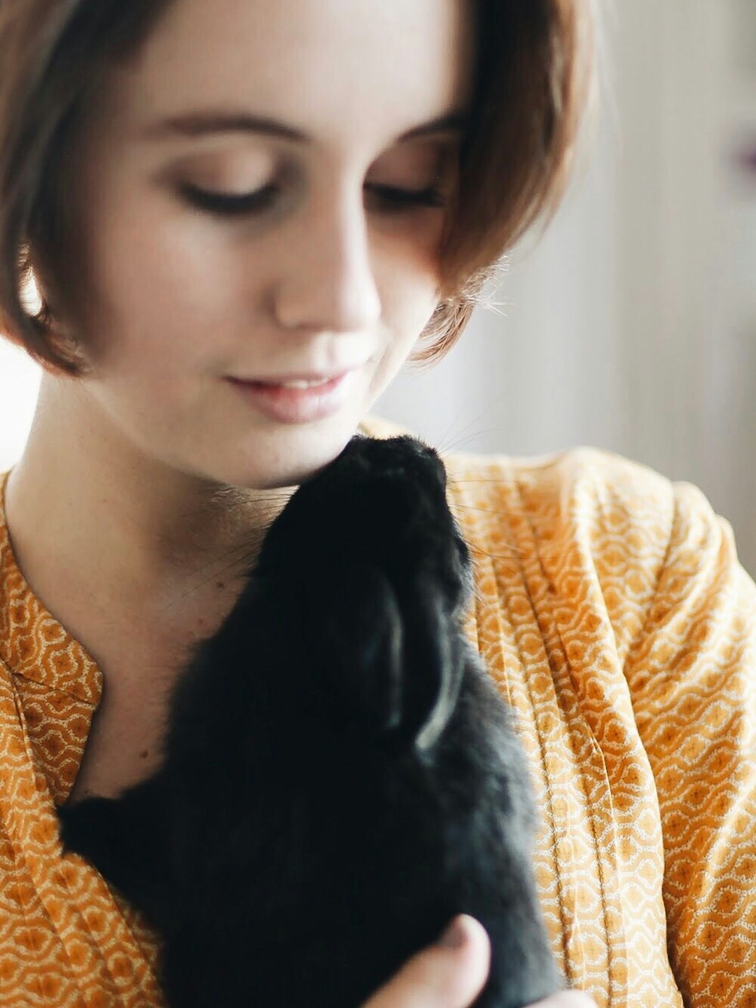 woman carrying black dog