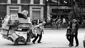 man dragging wagon with cardboard boxes