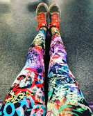 Close-up of elegant black and gray fitness leggings with subtle texture details on a clean white background.