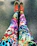 A happy customer holding a pair of colorful leggings with a bright smile.