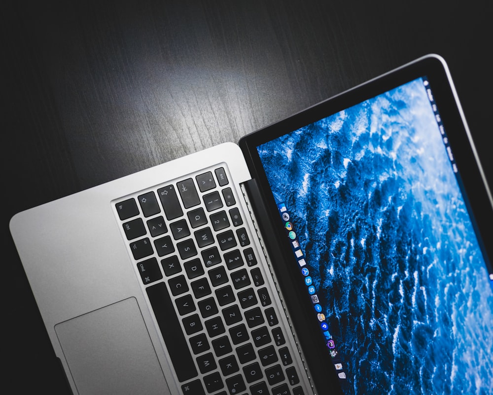 MacBook Pro on black wooden table