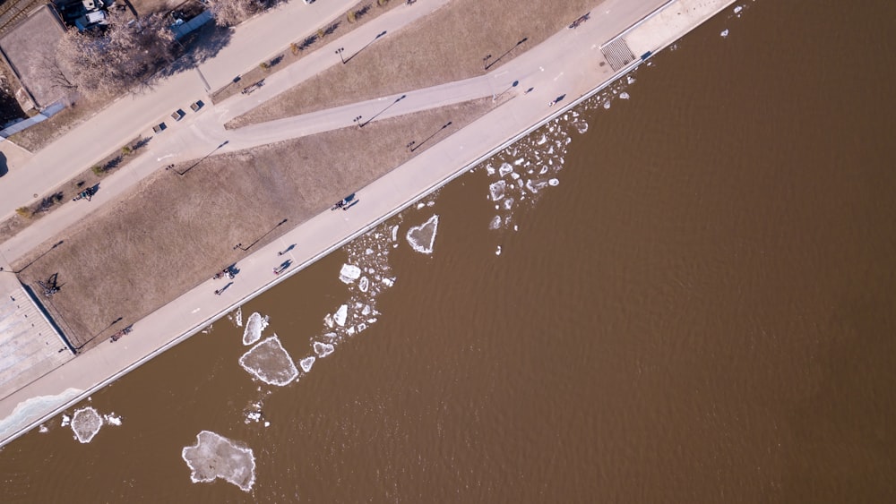 aerial photography of road near body of water
