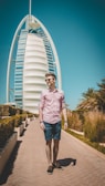 man walking on pathway near Burj Al, Dubai