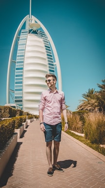man walking on pathway near Burj Al, Dubai