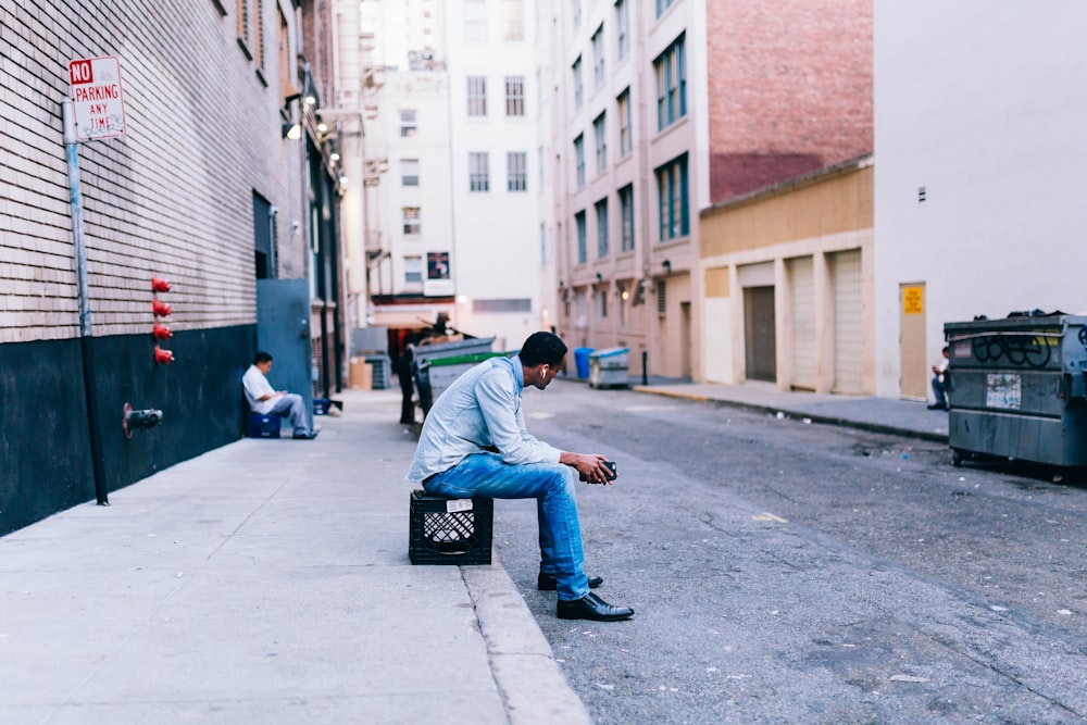 man sitting on crate