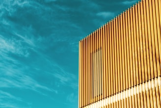 Exterior view of a modern gold refinery facility in Dubai under a clear blue sky.