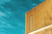 Finished aluminium facade gleaming under natural light on a contemporary building exterior.