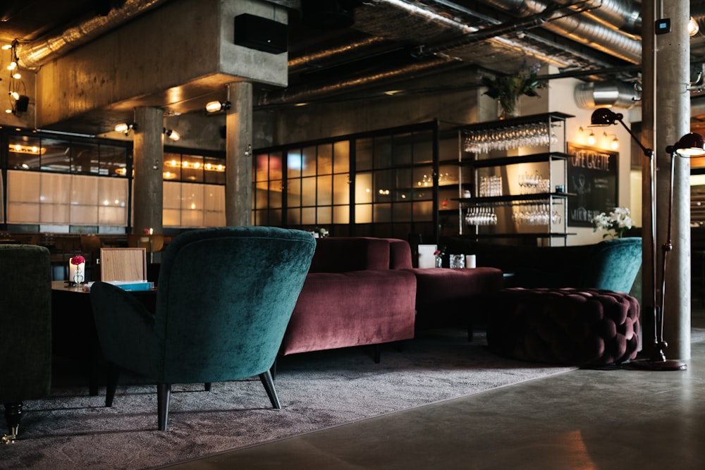 maroon and teal suede couches under brown roof