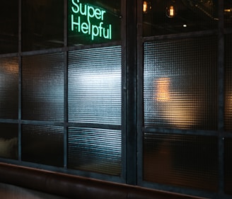 green Super helpful neon signage near window