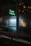 green Super helpful neon signage near window