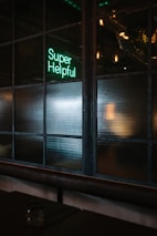 green Super helpful neon signage near window