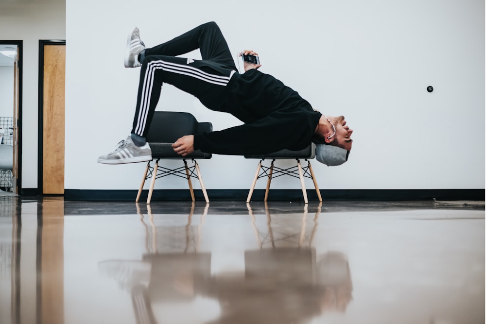 man sitting on chair near wall