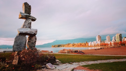 landscaped photo of a gray stone and buildings in English Bay Beach Canada