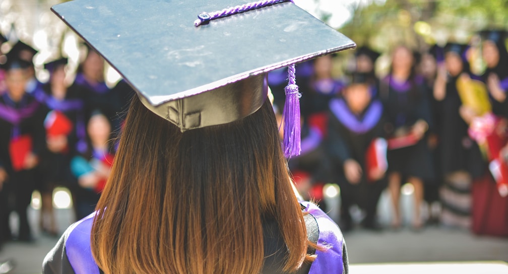 woman wearing academic cap and dress selective focus photography