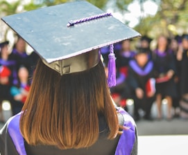 woman wearing academic cap and dress selective focus photography