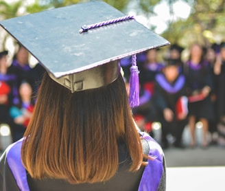 woman wearing academic cap and dress selective focus photography