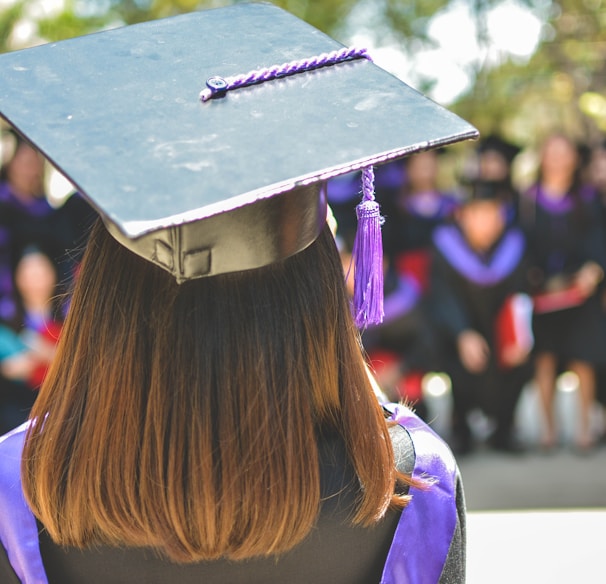 woman wearing academic cap and dress selective focus photography