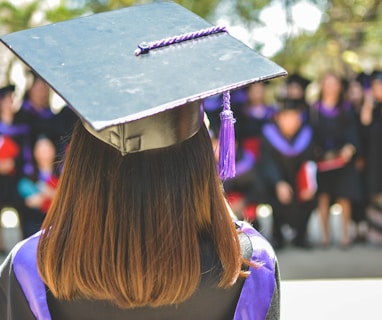 woman wearing academic cap and dress selective focus photography