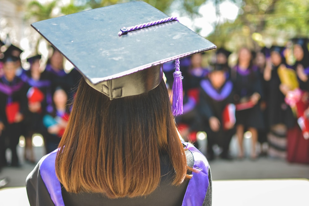 woman wearing academic cap and dress selective focus photography