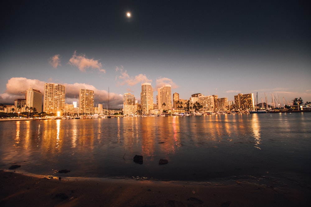 body of water near cityscape