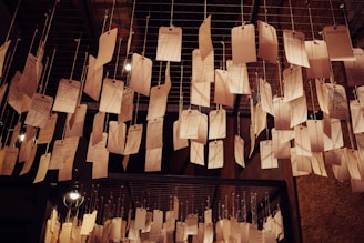 A cozy studio corner with handwritten lyric sheets pinned on a corkboard.