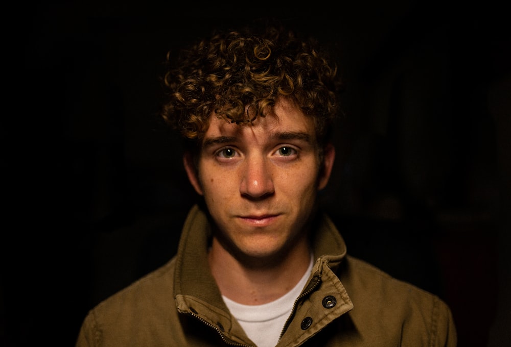 man wearing brown collared top