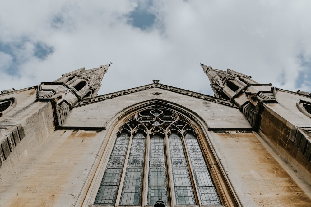 low angle photography of building under cloudy sky at daytime