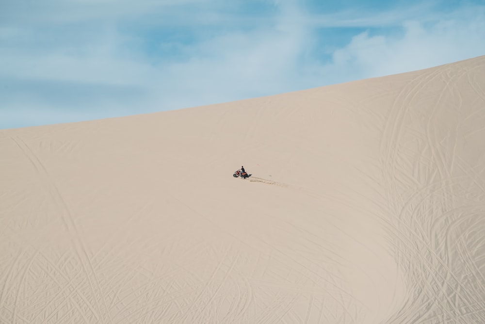 person riding motorcycle in the sand