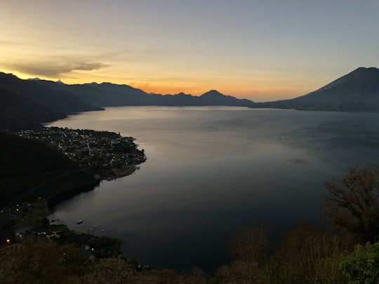 body of water between mountain at golden hour in Hotel Atitlan Guatemala